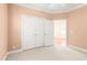 Bedroom with neutral carpet, crown molding, and walk-in closet at 2 Poplar Ave, Elon, NC 27244