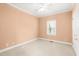 Bedroom featuring neutral carpet, a ceiling fan, and window allowing natural light to fill the room at 2 Poplar Ave, Elon, NC 27244