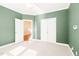 Bedroom with neutral carpet, crown molding, and double closets in a home at 2 Poplar Ave, Elon, NC 27244