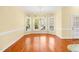 A sunny breakfast room with hardwood floors, large windows, and chandelier lighting at 2 Poplar Ave, Elon, NC 27244