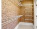 Walk-in closet with carpeted floor and built-in, white wire shelving for optimal storage at 2 Poplar Ave, Elon, NC 27244