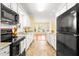 Bright kitchen overlooks sunny breakfast room with updated appliances and granite countertops at 2 Poplar Ave, Elon, NC 27244