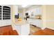 Bright kitchen features granite countertops, white cabinetry, and stainless steel appliances at 2 Poplar Ave, Elon, NC 27244