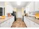 Open kitchen design with granite countertops, tile flooring, and modern appliances at 2 Poplar Ave, Elon, NC 27244