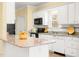Bright kitchen features granite countertops, white cabinetry, and black appliances at 2 Poplar Ave, Elon, NC 27244