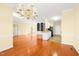 Open-concept living area with hardwood floors connecting to a modern kitchen and dining area at 2 Poplar Ave, Elon, NC 27244
