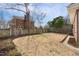 Spacious backyard features a wooden fence, mature tree, and the back of the brick home at 201 W Trinity Ave, Durham, NC 27701