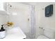 Bright bathroom featuring a white vanity, tub with tile surround, and modern fixtures at 201 W Trinity Ave, Durham, NC 27701