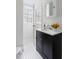 Bathroom with black vanity, quartz countertop, window, and tile flooring at 201 W Trinity Ave, Durham, NC 27701