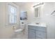 Well-lit bathroom featuring gray vanity, toilet and modern fixtures at 201 W Trinity Ave, Durham, NC 27701