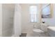 Clean bathroom featuring a shower with tub, toilet and modern decor at 201 W Trinity Ave, Durham, NC 27701