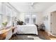 Bright bedroom with a desk, ceiling fan and large windows providing ample natural light at 201 W Trinity Ave, Durham, NC 27701
