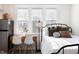 Comfortable bedroom with many windows and an area to study at 201 W Trinity Ave, Durham, NC 27701