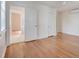 Bedroom with hardwood floors, white paint, and bathroom access at 201 W Trinity Ave, Durham, NC 27701