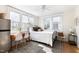 Bright bedroom with multiple windows, wooden desk, and light-colored carpet at 201 W Trinity Ave, Durham, NC 27701