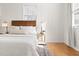 Serene bedroom with white walls, wood accents, and ample natural light at 201 W Trinity Ave, Durham, NC 27701