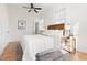 Cozy bedroom with wood-paneled walls, ceiling fan, and comfortable furnishings at 201 W Trinity Ave, Durham, NC 27701