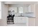 Kitchen with white cabinets, stainless steel appliances, and gray countertops at 201 W Trinity Ave, Durham, NC 27701