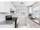 Modern kitchen featuring granite countertops, stainless steel appliances, and bright white cabinets at 201 W Trinity Ave, Durham, NC 27701