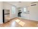 Bright open-concept kitchen features stainless steel appliances and white cabinets at 201 W Trinity Ave, Durham, NC 27701