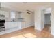 Kitchen with hardwood floors, white cabinets, and modern appliances at 201 W Trinity Ave, Durham, NC 27701