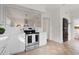 Charming kitchen with stainless steel oven and white cabinets, flowing into dining area at 201 W Trinity Ave, Durham, NC 27701