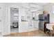 Efficient kitchen with stainless refrigerator, white cabinets and bright natural light at 201 W Trinity Ave, Durham, NC 27701