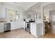 Spacious kitchen features stainless steel appliances, white cabinetry, and seamless access to dining area at 201 W Trinity Ave, Durham, NC 27701