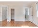 Bright living room with hardwood floors, white paint, and multiple doorways at 201 W Trinity Ave, Durham, NC 27701