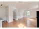 Bright living room with hardwood floors, white paint, and kitchen access at 201 W Trinity Ave, Durham, NC 27701