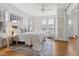 Bright main bedroom features hardwood floors, ceiling fan, and access to sitting area at 201 W Trinity Ave, Durham, NC 27701