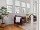 Bright sitting room with large windows and stylish leather armchair and hardwood floors at 201 W Trinity Ave, Durham, NC 27701