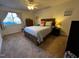 Cozy bedroom featuring a ceiling fan, neutral color palette, and plush queen bed at 203 Oak Tree Dr, Chapel Hill, NC 27517