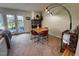 Bright dining area with a brick fireplace, modern lighting, and view of outdoor patio at 203 Oak Tree Dr, Chapel Hill, NC 27517