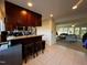 Kitchenette with barstool seating, granite counter, and connection to living room at 203 Oak Tree Dr, Chapel Hill, NC 27517