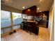 Kitchenette with granite counter, dark wood cabinets, and view of neighborhood at 203 Oak Tree Dr, Chapel Hill, NC 27517