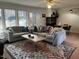 Inviting living room with a brick fireplace, large sectional, and decorative area rug at 203 Oak Tree Dr, Chapel Hill, NC 27517