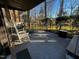 Covered patio with rocking chairs overlooking the backyard at 203 Oak Tree Dr, Chapel Hill, NC 27517