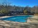 Community pool features crystal clear water, handrails, and a large concrete deck for lounging with nearby condos at 203 Oak Tree Dr, Chapel Hill, NC 27517