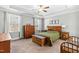 Bright bedroom featuring wood furniture, neutral walls, carpet flooring, and a ceiling fan with light at 238 Ashpole Trail Trl, Clayton, NC 27520