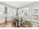 Cozy dining area features a wood table, white chairs, and natural light from multiple windows at 238 Ashpole Trail Trl, Clayton, NC 27520