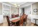 Cozy dining area with an ornate wooden table, with stairs and kitchen in view at 238 Ashpole Trail Trl, Clayton, NC 27520