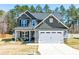 Charming two-story home with a well-manicured lawn and an attached two-car garage at 238 Ashpole Trail Trl, Clayton, NC 27520