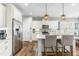 Bright kitchen with white cabinets, stainless steel appliances, and a center island with breakfast bar seating at 238 Ashpole Trail Trl, Clayton, NC 27520