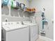 Functional laundry room with white washer and dryer, shelving, and convenient storage solutions at 238 Ashpole Trail Trl, Clayton, NC 27520