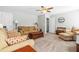 Living room featuring tan couches and chairs, carpet flooring and ceiling fan with lighting at 238 Ashpole Trail Trl, Clayton, NC 27520