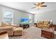 Living room featuring two windows, tan couches and chairs and carpet flooring at 238 Ashpole Trail Trl, Clayton, NC 27520