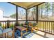 Enjoy the outdoor screened porch with cozy seating and views of the tree-lined backyard at 238 Ashpole Trail Trl, Clayton, NC 27520
