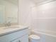 Bright bathroom featuring a combination shower-tub, white cabinets, and a stylish granite countertop at 267 Parkland Dr Dr, Pittsboro, NC 27312