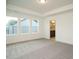Spacious bedroom with natural light features neutral carpet, white walls, and tray ceilings with ensuite at 267 Parkland Dr Dr, Pittsboro, NC 27312